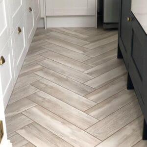Herringbone wood effect tile flooring in a kitchen