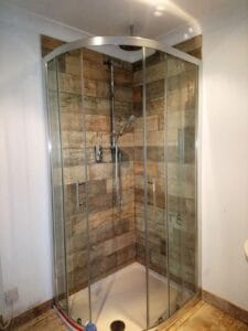 Old reclaimed wood effect porcelain tiles in shower cubicle with tiled bathroom floor with porcelain planks