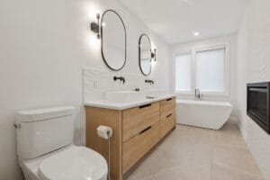 White feature tiled splashback in bathroom with large format floor tiles