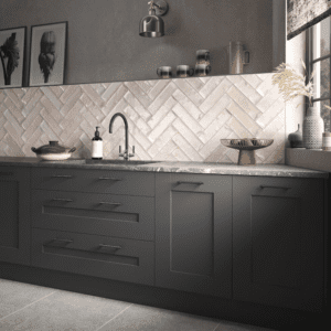 Baby pink metro style tiled splashback in a kitchen with dark grey units