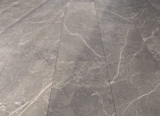 Grey marble large format tiles on a floor laid in a brick pattern