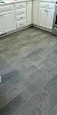 dark grey granite effect porcelain tiling of a kitchen floor in a brick pattern
